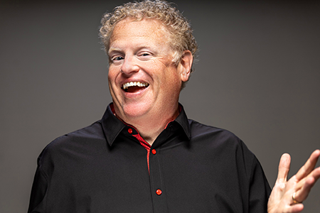 Andy Forrester smiling hand up